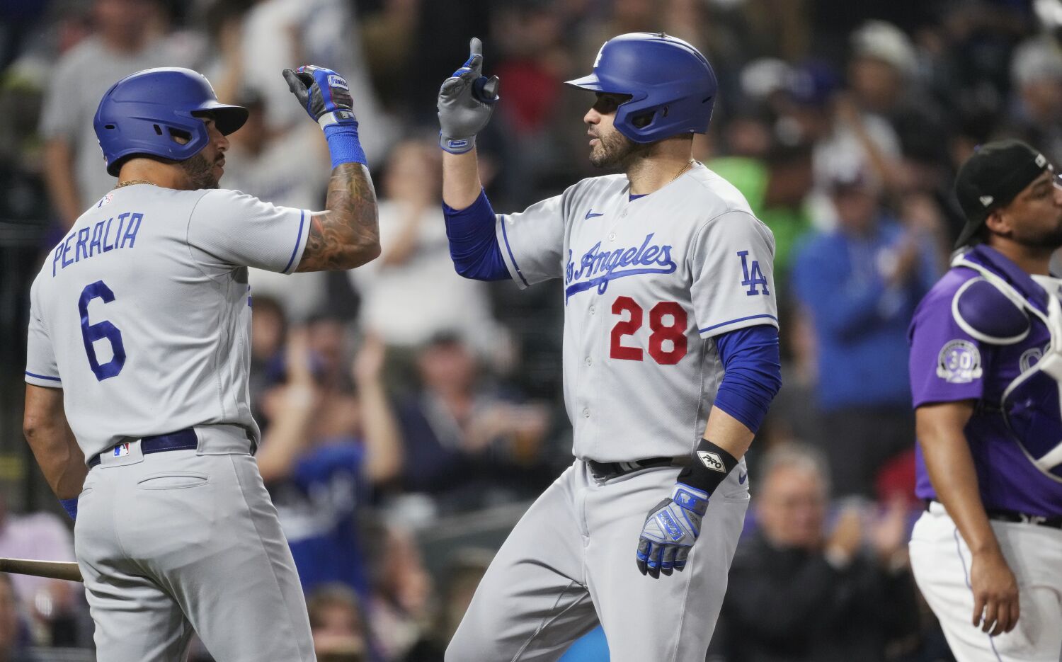 Dodgers come up swinging after weather delay to rout Rockies