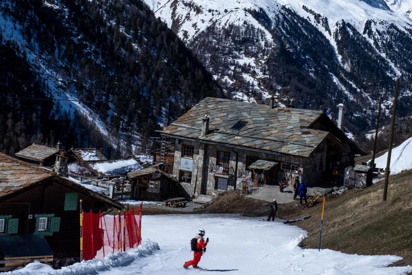 Snowboarding through Alpine villages in Zermatt.