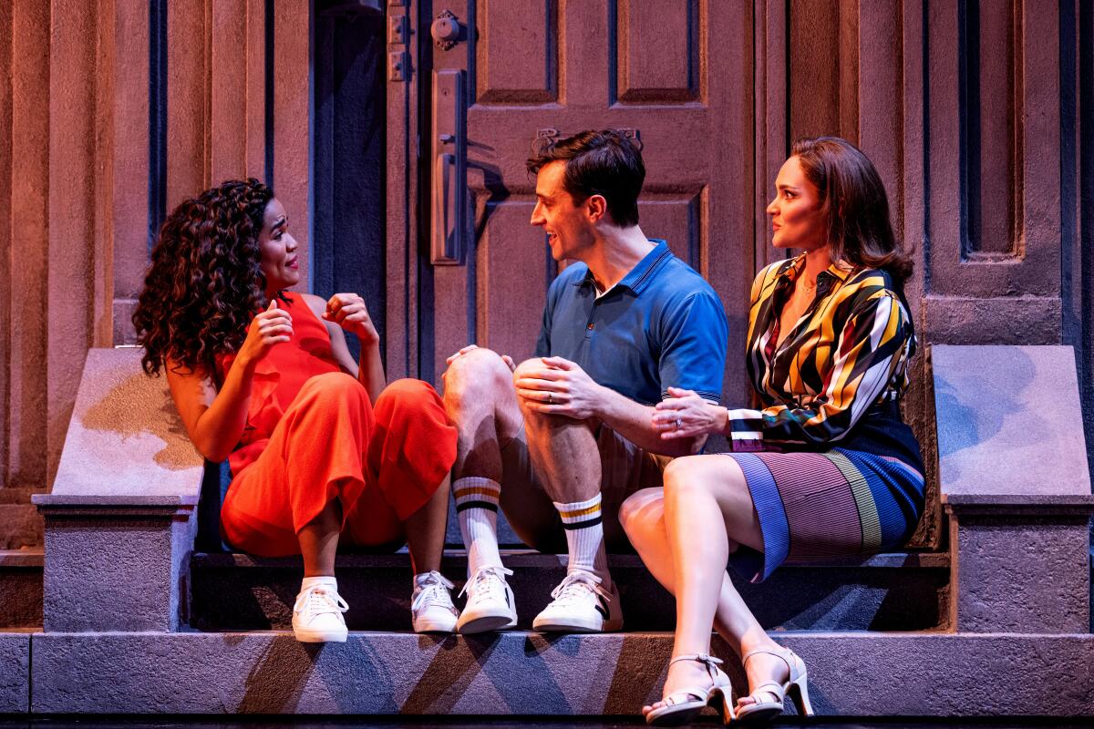 Britney Coleman as Bobbie, Matthew Christian as David and Emma Stratton as Jenny sit on a stoop in "Company."