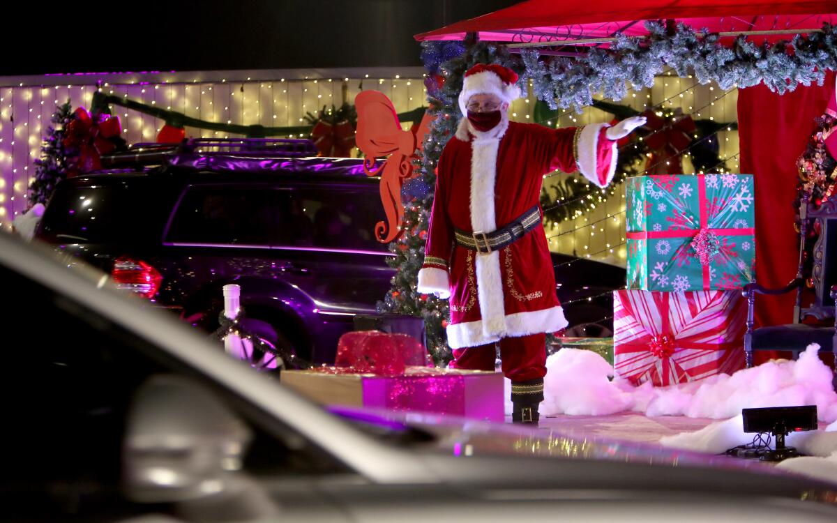Santa waves to drive-thru participants during the Night of Lights OC at the OC Fairgrounds in Costa Mesa.