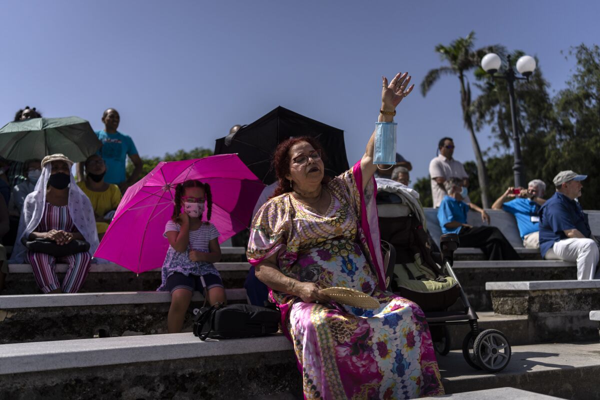 Baptists worship in an amphitheater more than a month after their church was severely damaged in the explosion at the Hotel Saratoga, in Havana, Cuba, Sunday, June 12, 2022. The gas leak that caused the explosion of the Saratoga on May 6, also damaged neighboring buildings including the Calvary Baptist Church. (AP Photo/Ramon Espinosa)