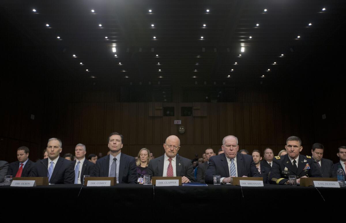 Director of National Intelligence James Clapper, center, and other security agency officials, testify on Capitol Hill.