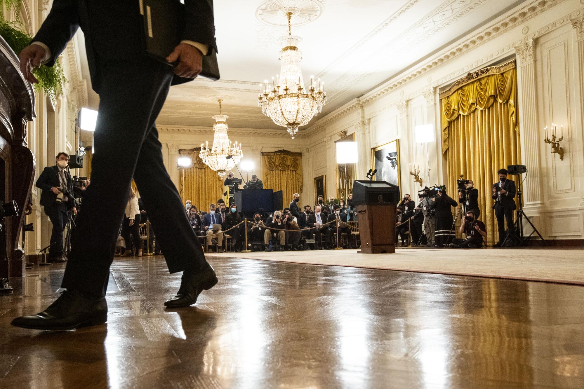 President Biden departs the East Room of the White House.