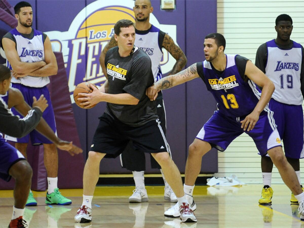 Mark Madsen helps out with the Lakers summer league camp invitees on July 10 at Toyota Sports Center in El Segundo.