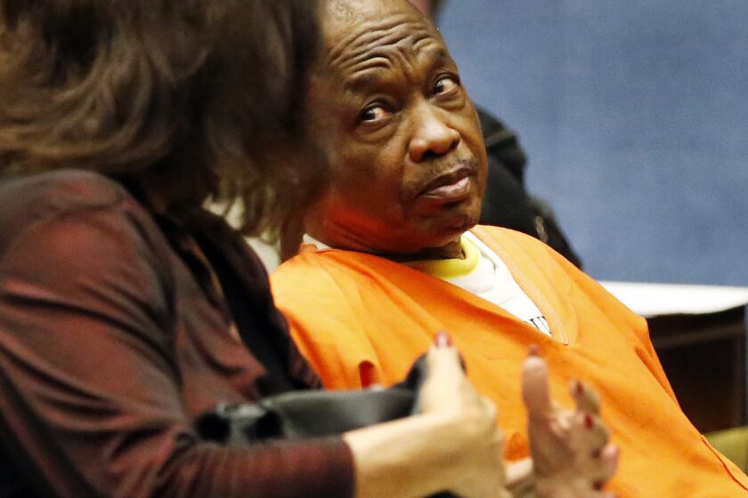 Lonnie Franklin Jr., the alleged Grim Sleeper serial killer, listens to one of his attorneys, Louisa Pensanti, during a pretrial hearing on Aug. 17, 2015.