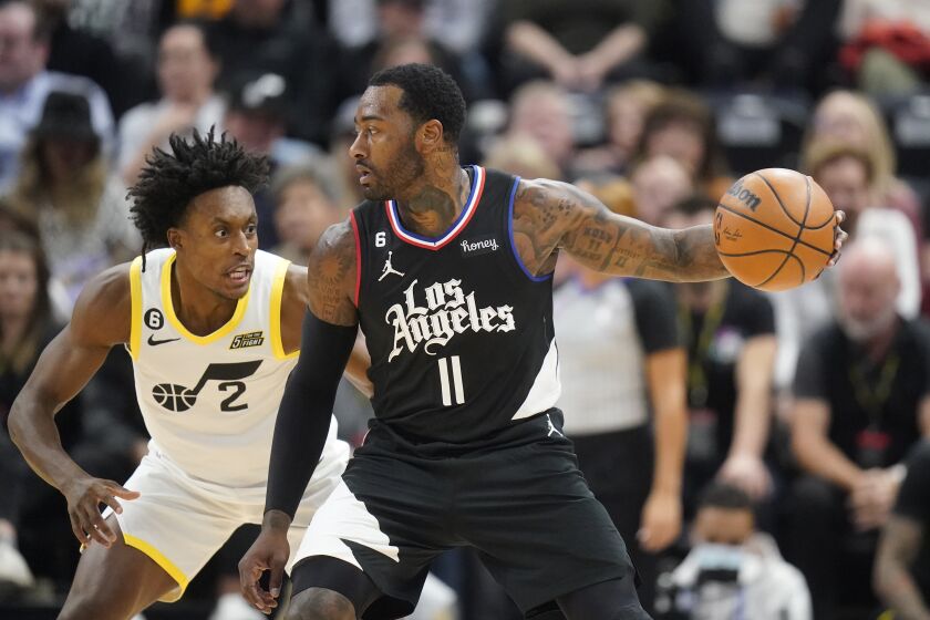 Utah Jazz guard Collin Sexton (2) defends Los Angeles Clippers guard John Wall (11) during the first half of an NBA basketball game Wednesday, Nov. 30, 2022, in Salt Lake City. (AP Photo/Rick Bowmer)