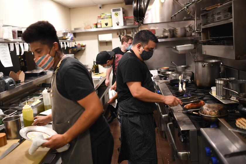 LONG BEACH, CALIFORNIA NOVEMBER 25, 2020-Chef's work in the kitchen at Michael's in the Naples area of Long Beach Wednesday. November 25th was the last day for outdoor dining in L.A. County as officails try to slow down the spread of the coronavirus. (Wally Skalij/Los Angeles Times)