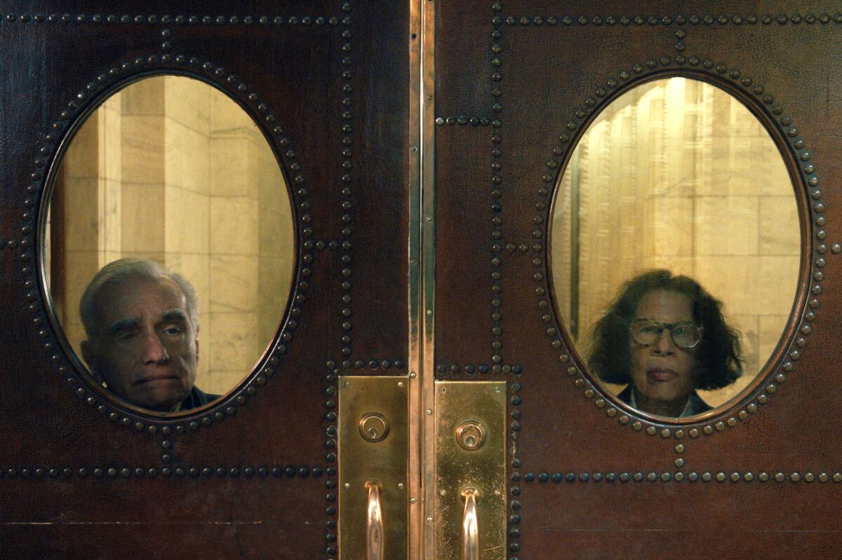 Fran Lebowitz  and Martin Scorsese peek out through door windows in "Pretend It's a City."