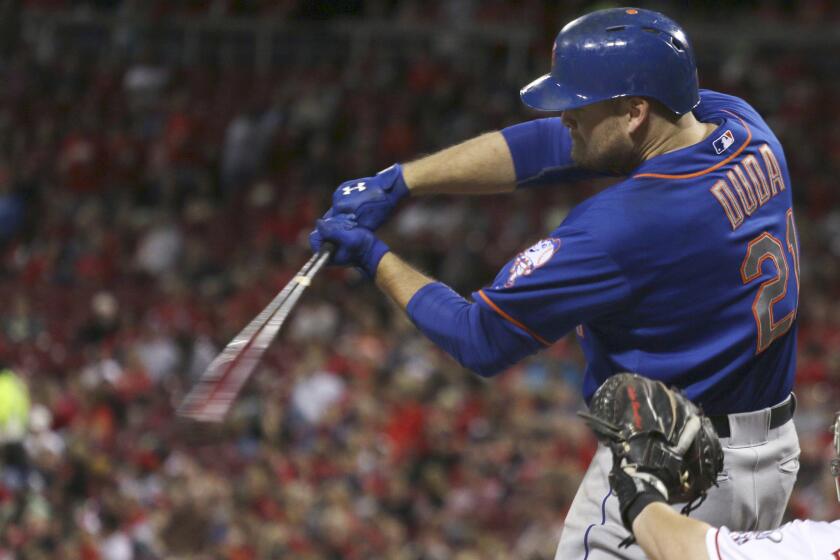 New York Mets first baseman Lucas Duda hits a three-run home run against the Cincinnati Reds during the seventh inning of a game on Sept. 25.