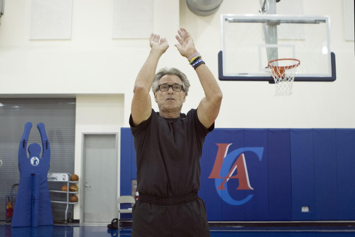 NBA Shooting Coach Bob Thate shows the mechanics of shooting the ball during a session with Los Angeles Times Reporter Chris Erskine.