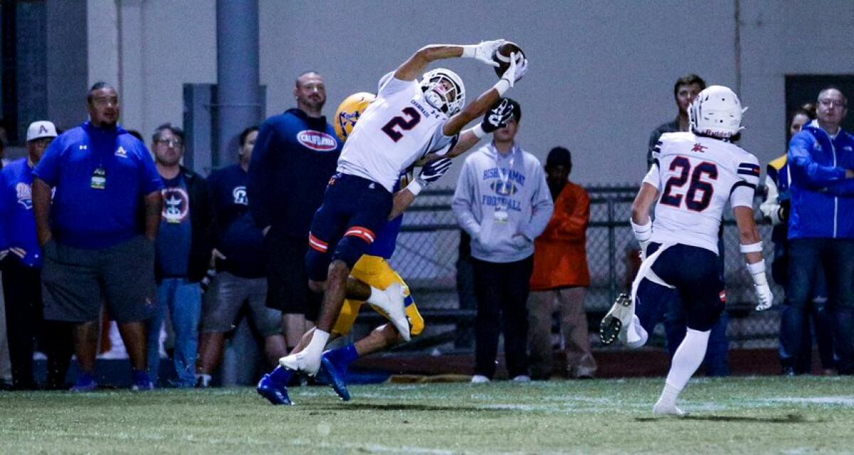 Marquis Gallegos, playing for Chaminade last season, reaches overhead to make an interception against Bishop Amat.