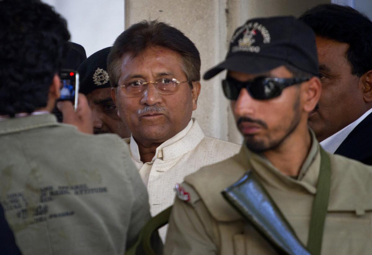 Pakistan's former president and military ruler Gen. Pervez Musharraf, center, leaves after appearing in court in Rawalpindi, Pakistan, in April.