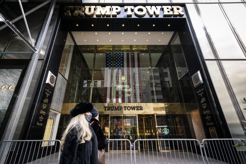Pedestrians pass security barricades in front of Trump Tower, Wednesday, Feb. 17, 2021, in New York. Former President Donald Trump owns a penthouse condominium in the skyscraper and the Trump Organization has its headquarters here. (AP Photo/John Minchillo)