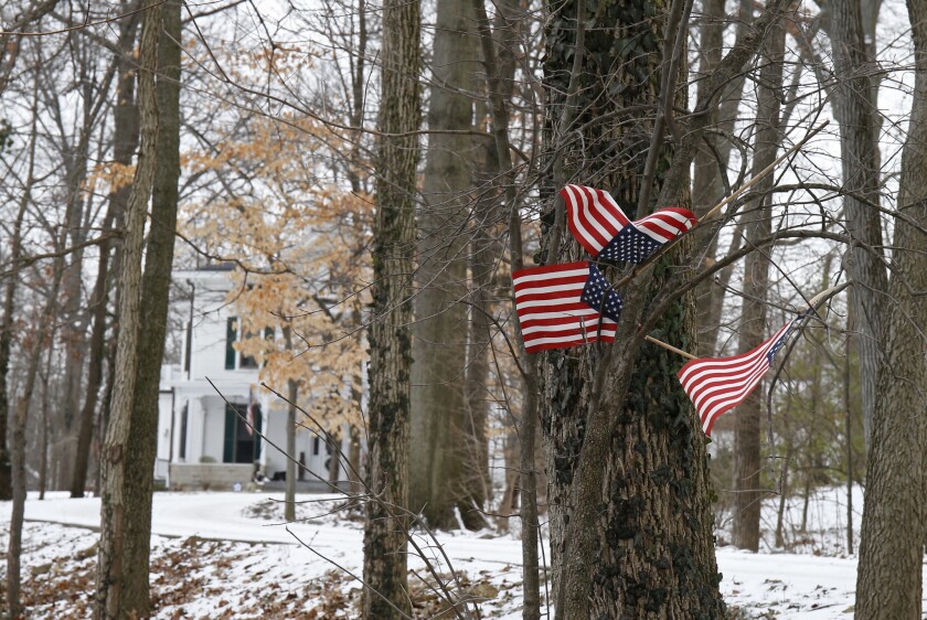 Small American flags have been placed in the trees outside the Warmbier family home in Wyoming, Ohio.