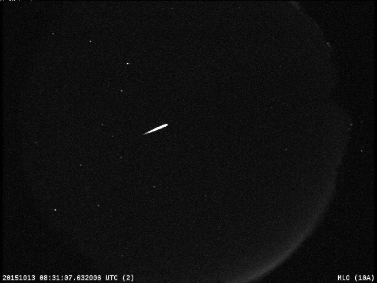 Streak of a meteor on a black-sky background.