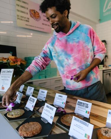 Co-owner of Lei'd Cookie, James Lewis sets up for opening