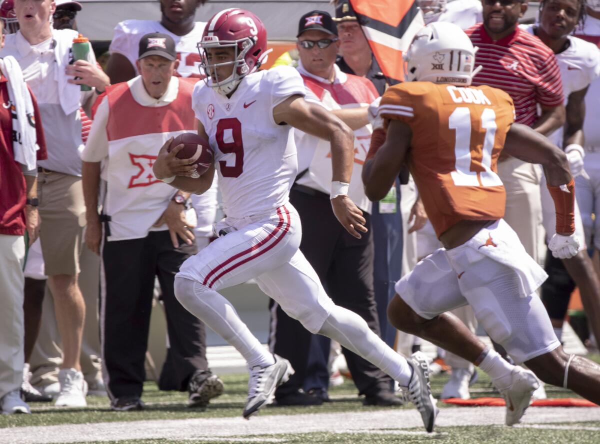 Alabama quarterback Bryce Young (9) is chased out of bounds by Texas defensive back Anthony Cook during the second half of an NCAA college football game, Saturday, Sept. 10, 2022, in Austin, Texas. Alabama defeated Texas 20-19. (AP Photo/Rodolfo Gonzalez)