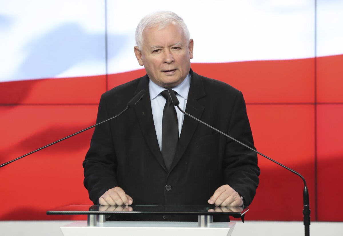 The leader of the Polish ruling party, Jaroslaw Kaczynski,center, speaks to reporters in Warsaw, Poland, Saturday, Sept. 26, 2020. The three parties in Poland's conservative coalition government signed a new coalition agreement on Saturday, putting aside disagreements. But they gave no details, leaving lingering uncertainty about how the Cabinet will look in practice after an expected reshuffle.(AP Photo/Czarek Sokolowski)