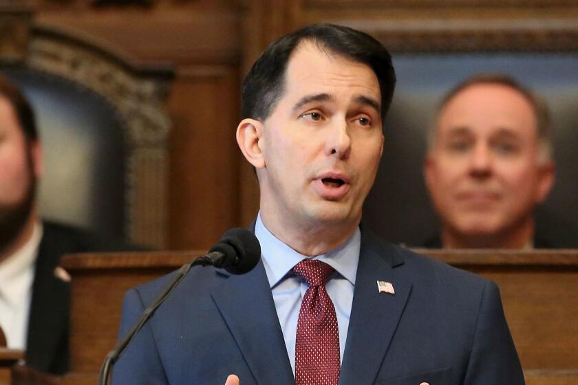 FILE - In this Feb. 8, 2017 file photo, Wisconsin Gov. Scott Walker delivers his state budget address at the state Capitol in Madison. Text messages exchanged between Walker and fellow Republican Assembly Speaker Robin Vos show private tensions as they bicker over the state budget. Copies of the messages were released Friday, April 7, 2017, by the governor's office to The Associated Press. (John Hart /Wisconsin State Journal via AP, File)