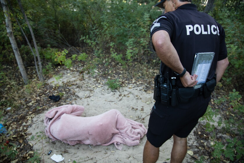 Boise police Sgt. Craig Nixon checks on a homeless man.