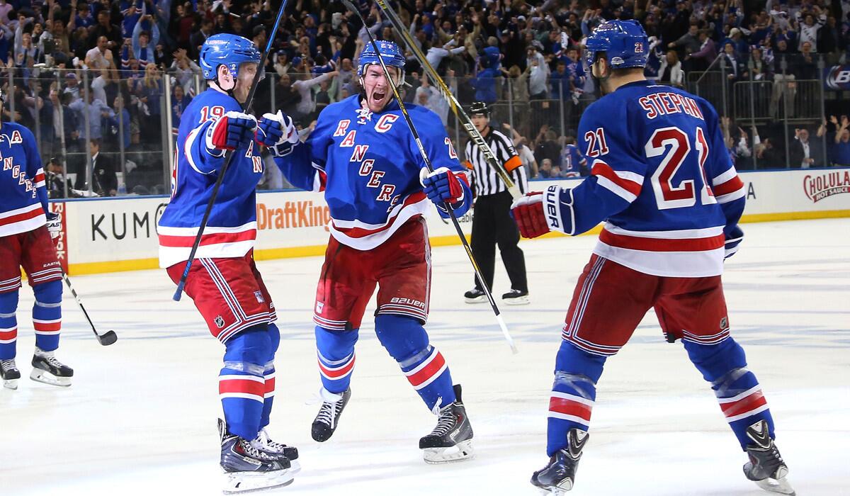 New York Rangers' Ryan McDonagh, center, celebrates his game winning goal at 9:37 of overtime against the Washington Capitals and is joined by Jesper Fast, left, and Derek Stepan in Game 5 of the Eastern Conference semifinals of the Stanley Cup Playoffs on Friday.
