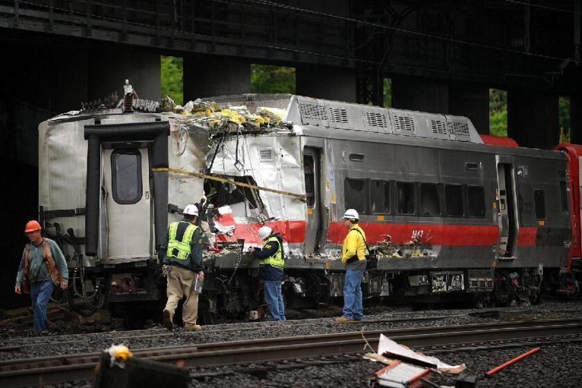 Crews work at the site of a train derailment in Bridgeport, Conn., that left dozens injured. The tracks require extensive repair; commuters were urged to carpool or stay home.