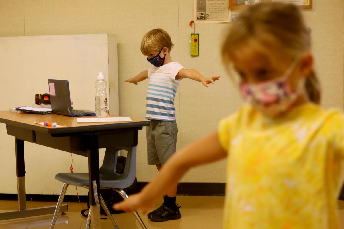 Students participate in a Zoom lesson from a class overseen by teachers with the YMCA at Anza Elementary School