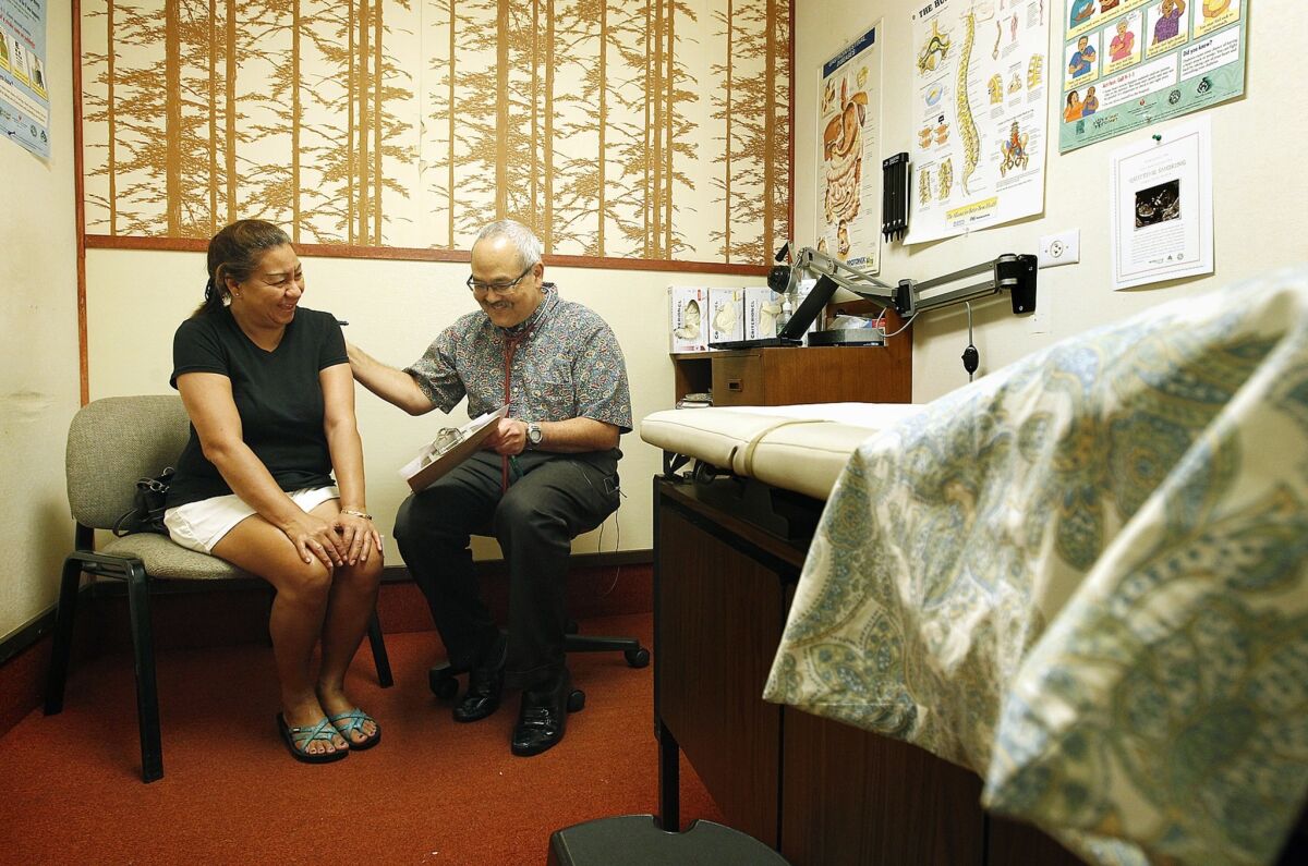 Ramona Engoring, left, sees Dr. Randall Suzuka for a checkup at Haleiwa Family Clinic in Haleiwa, Hawaii, in a rural area of Oahu once covered with sugar cane plantations. Suzuka took over a former plantation doctor's practice.