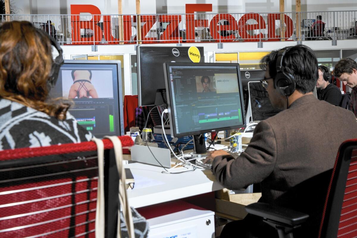 Buzzfeed workers edit videos at the website's Los Angeles offices in 2013.