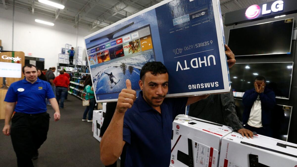 TV deals should abound as the Super Bowl approaches, just as they did around Thanksgiving, when these shoppers in Mesquite, Texas, took advantage of low prices.