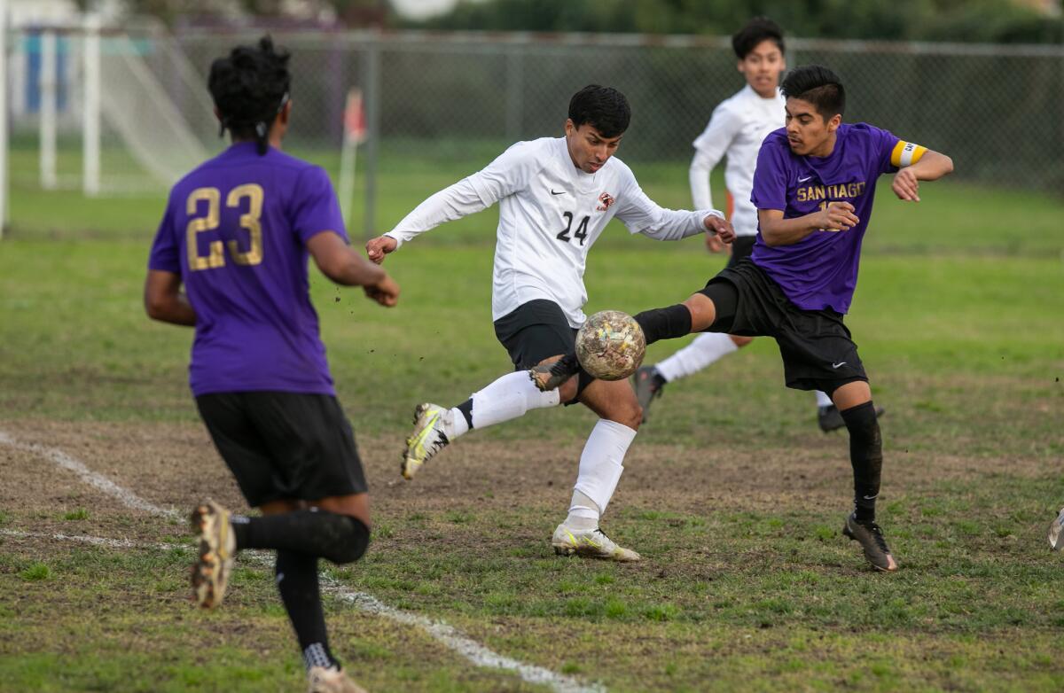 Los Amigos' Daniel Perez and Santiago's Bryant Pineda battle for a ball in a Garden Grove League boys' soccer match.