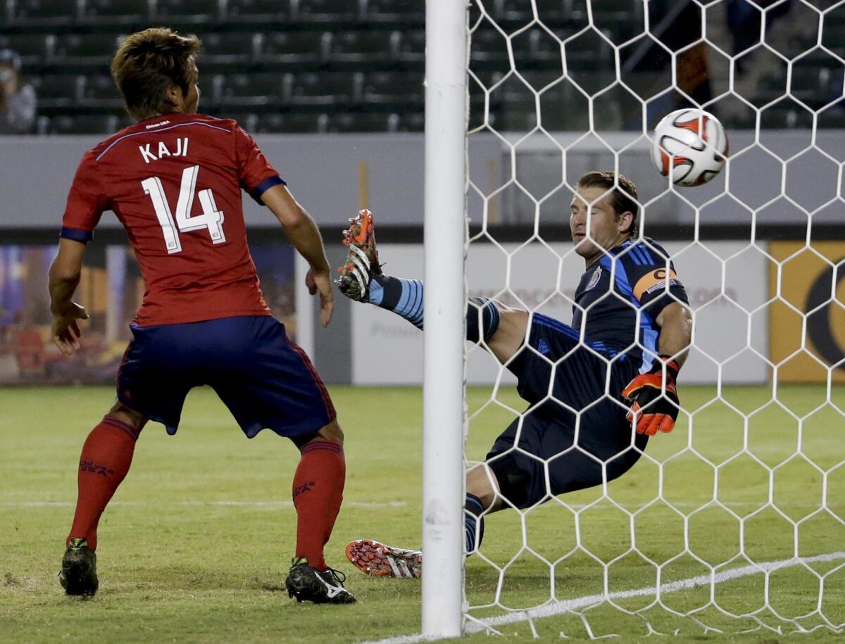 Chivas USA's Akira Kaji, left, and goalkeeper Dan Kennedy watch a goal by Seattle's Obafemi Martins during the first half of a match on Sept. 3.