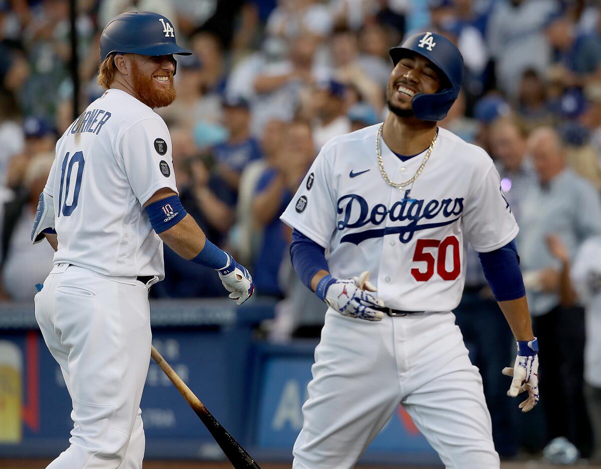 Dodgers second baseman Mookie Betts is congratulated by teammate Justin Turner.
