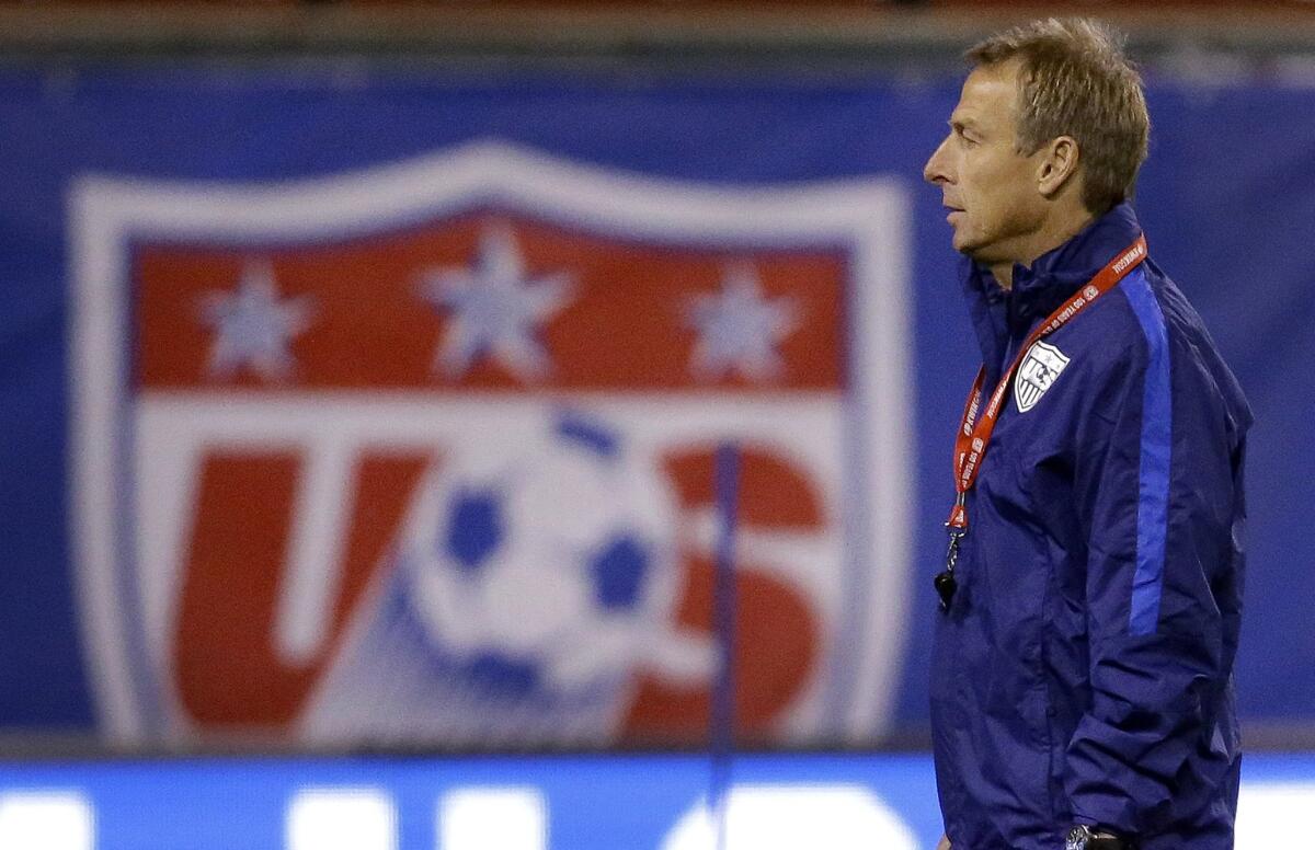 United States men's national team Coach Juergen Klinsmann watches his team warm up during practice Nov. 12.