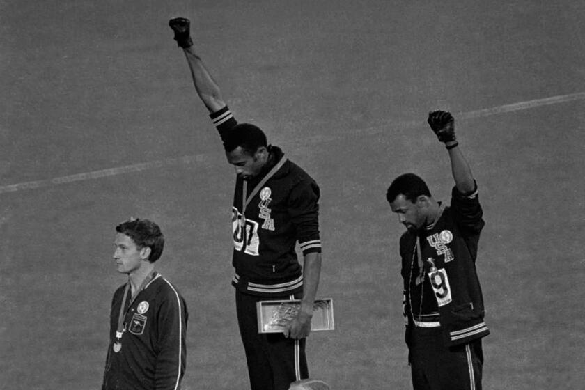 In this Oct. 16, 1968 file photo, U.S. athletes Tommie Smith and John Carlos extend their gloved fists skyward.