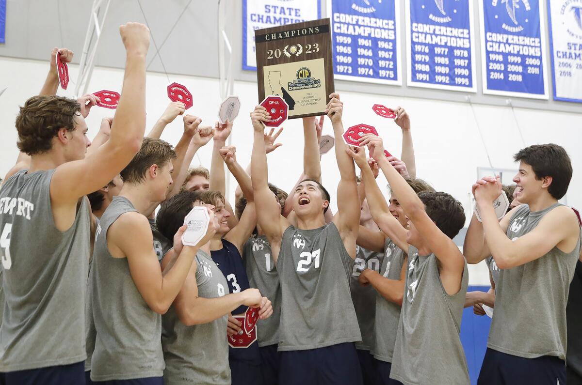 Korbin Francisco (27) proudly holds the 2023 CIF Southern Section Division 1 boys' volleyball championship trophy.