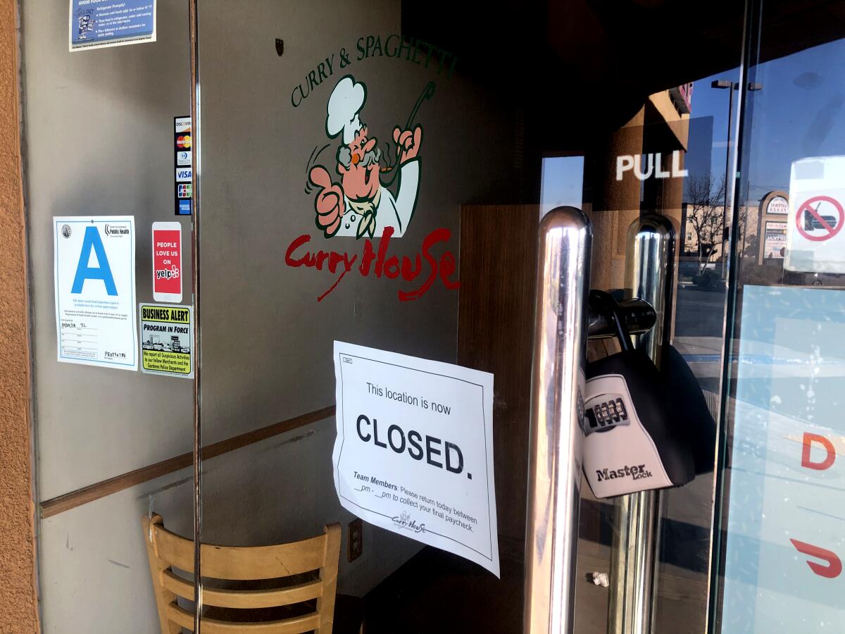 A sign posted at the Curry House location in Gardena informed workers that their final paychecks could be picked up at a later date.