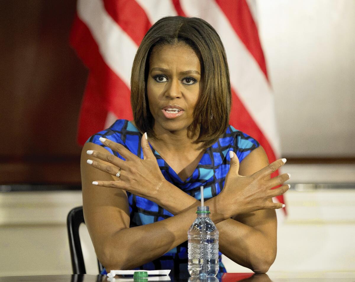 First Lady Michelle Obama takes part in a discussion on school lunch nutrition in Washington, where she launched a defense of the law she championed that set higher standards for the food children receive at school.