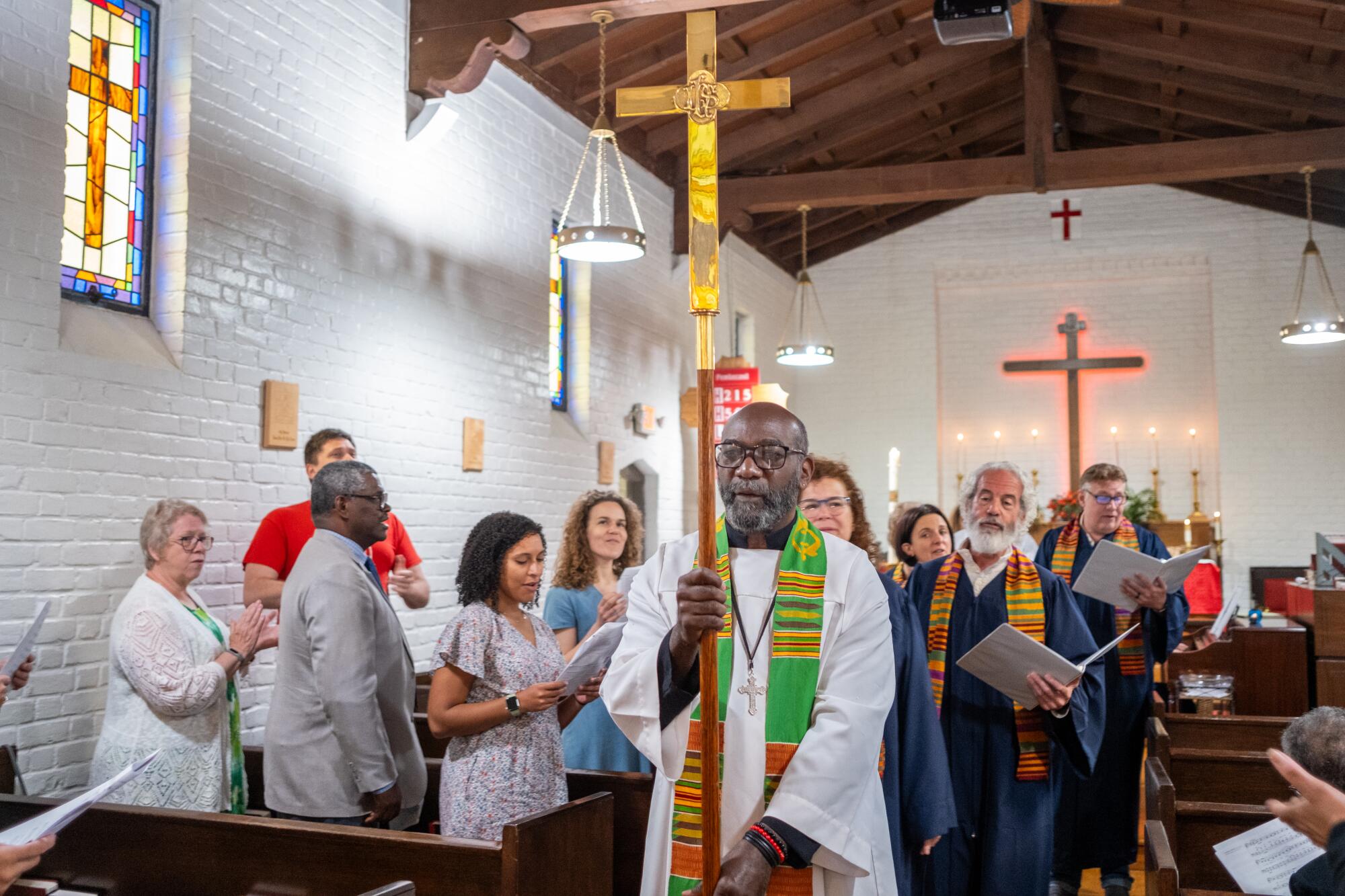 Worshipers stand in a church