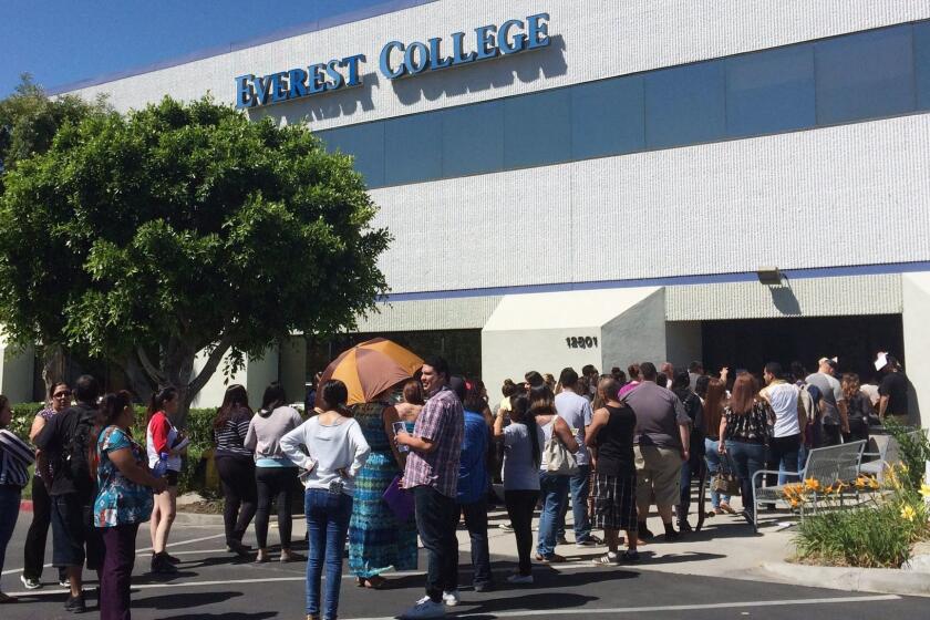 FILE - In this April 28, 2015 file photo, students wait outside Everest College in Industry, Calif., hoping to get their transcriptions and information on loan forgiveness and transferring credits to other schools. Almost 12,000 students are asking the federal government to discharge their college loan debt, asserting that their school either closed or lied to them about job prospects, according to government data released Thursday. The figure represents an unprecedented spike in what's called a "borrower's defense" claim following the collapse of Corinthian Colleges, a for-profit college chain that had become a symbol of fraud in the world of higher education. Under higher education law, students who believe they were victims of fraud can apply to have their loans discharged. (AP Photo/Christine Armario)