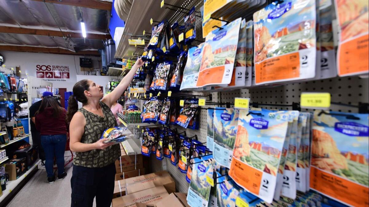 Customers shop for supplies, including food and water, at SOS Survival Products.