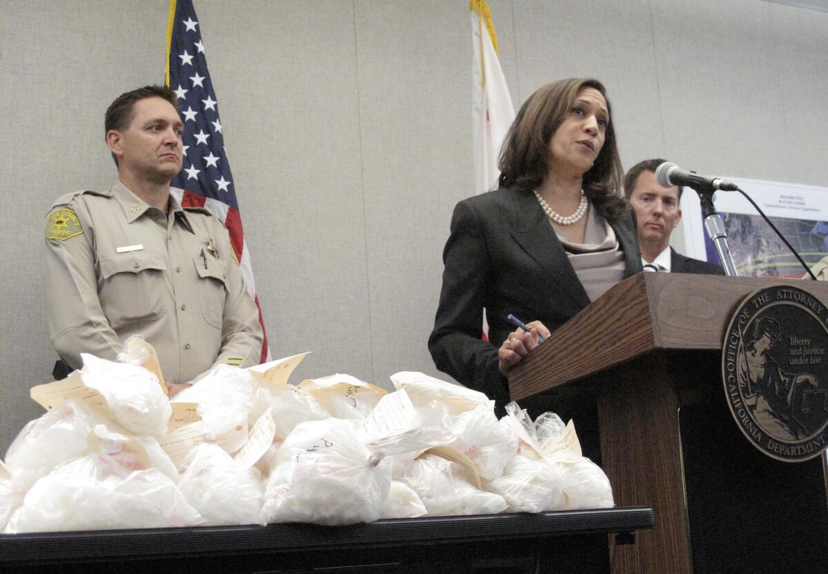 California Atty. Gen. Kamala Harris announces the action against the drug trafficking organization during a news conference Monday in Fresno. On the table are bags of crystal methamphetamine.