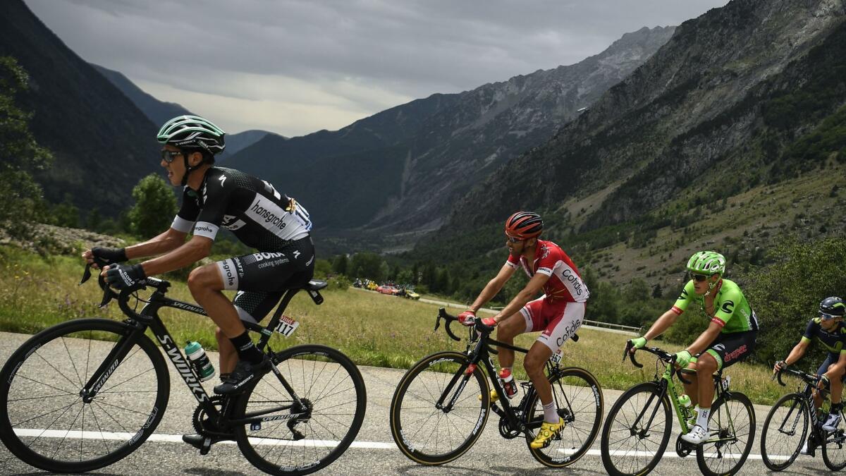 Poland's Pawel Poljanski, left, with Spain's Daniel Navarro and Switzerland's Michael Albasini during the 17th stage of the Tour de France on July 19.