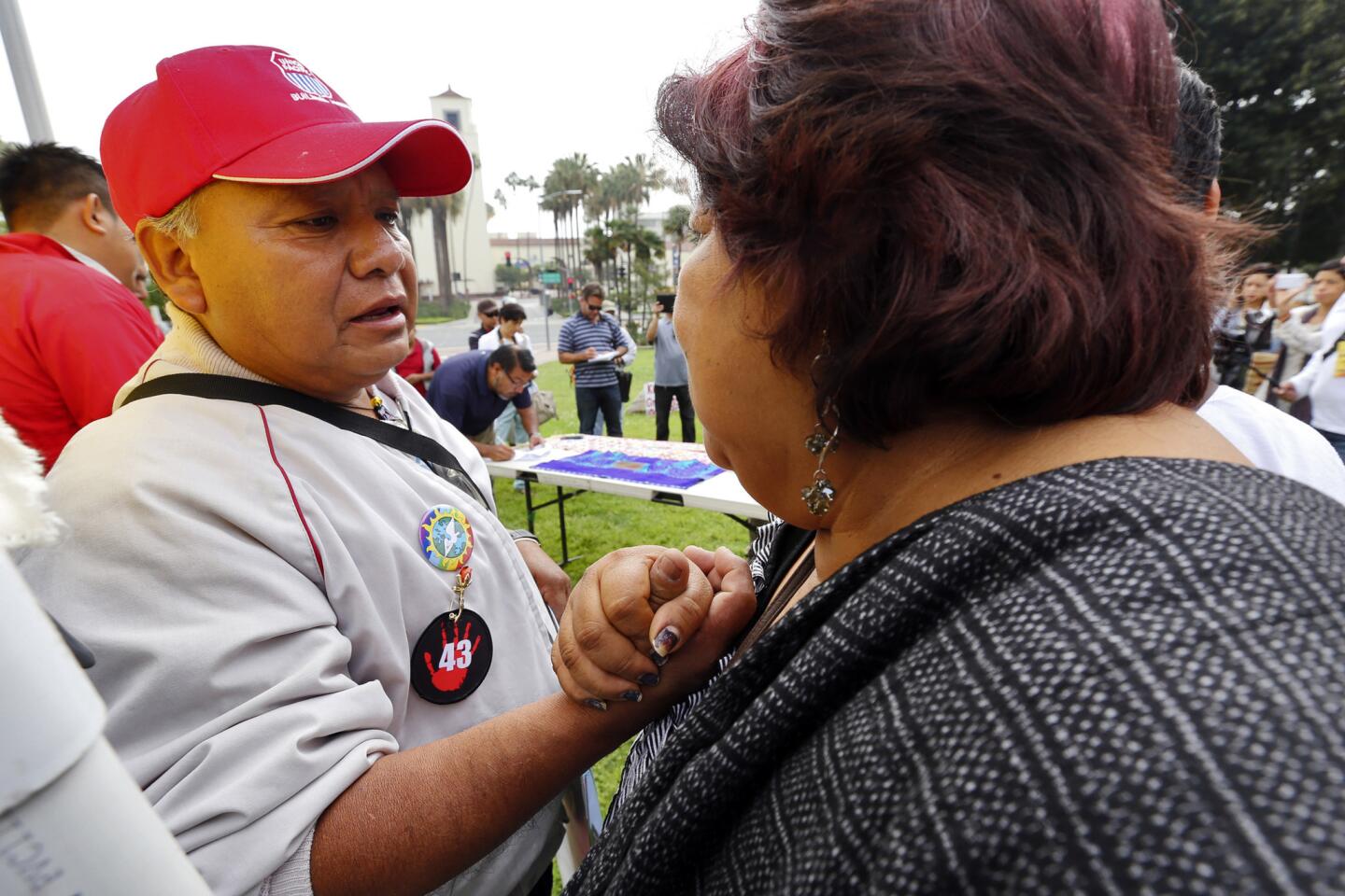 Estanislao Mendoza Chocalate, left, father of missing student Miguel Angel Mendoza Zacarias, receives support from Juana Nicolas at the rally. Some family members of 43 missing students from Ayotzinapa, Mexico, held a rally on March 21, 2015 at Olvera Street to raise awareness.