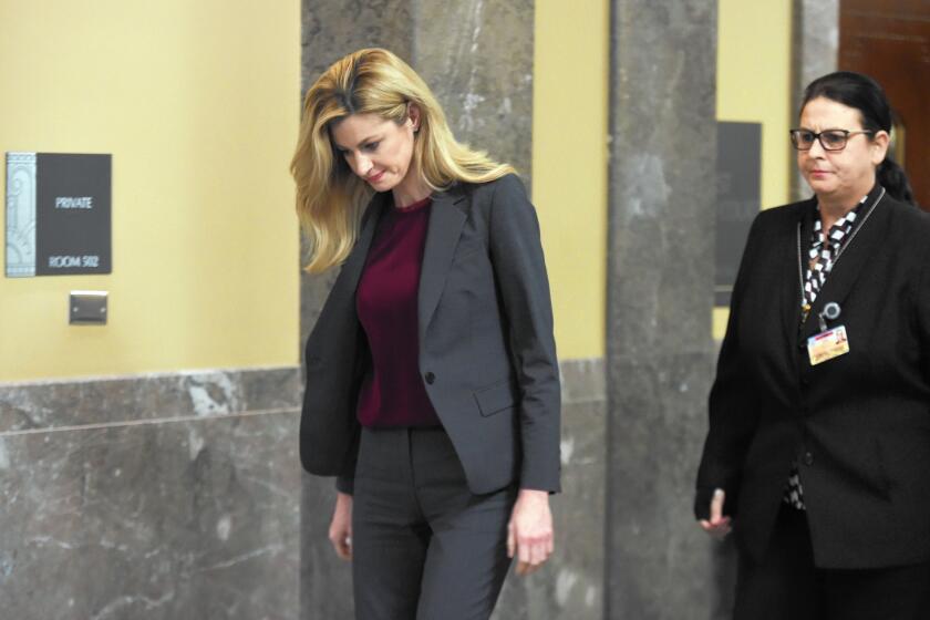 Sportscaster Erin Andrews, left, who was the victim of a hotel stalking, leaves the courtroom in Nashville, Tenn.