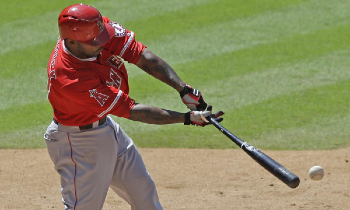Angels second baseman Howie Kendrick connects on a run-scoring single during the seventh inning of the Angels' 9-1 victory over the Houston Astros on Monday.