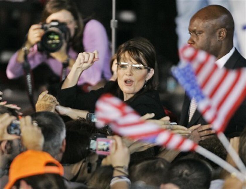 Republican vice presidential candidate Alaska Gov. Sarah Palin grrets supporters after a rally with running mate Sen. John McCain, R-Ariz., in Vienna, Ohio, Tuesday, Sept. 16, 2008. (AP Photo/Mark Duncan)