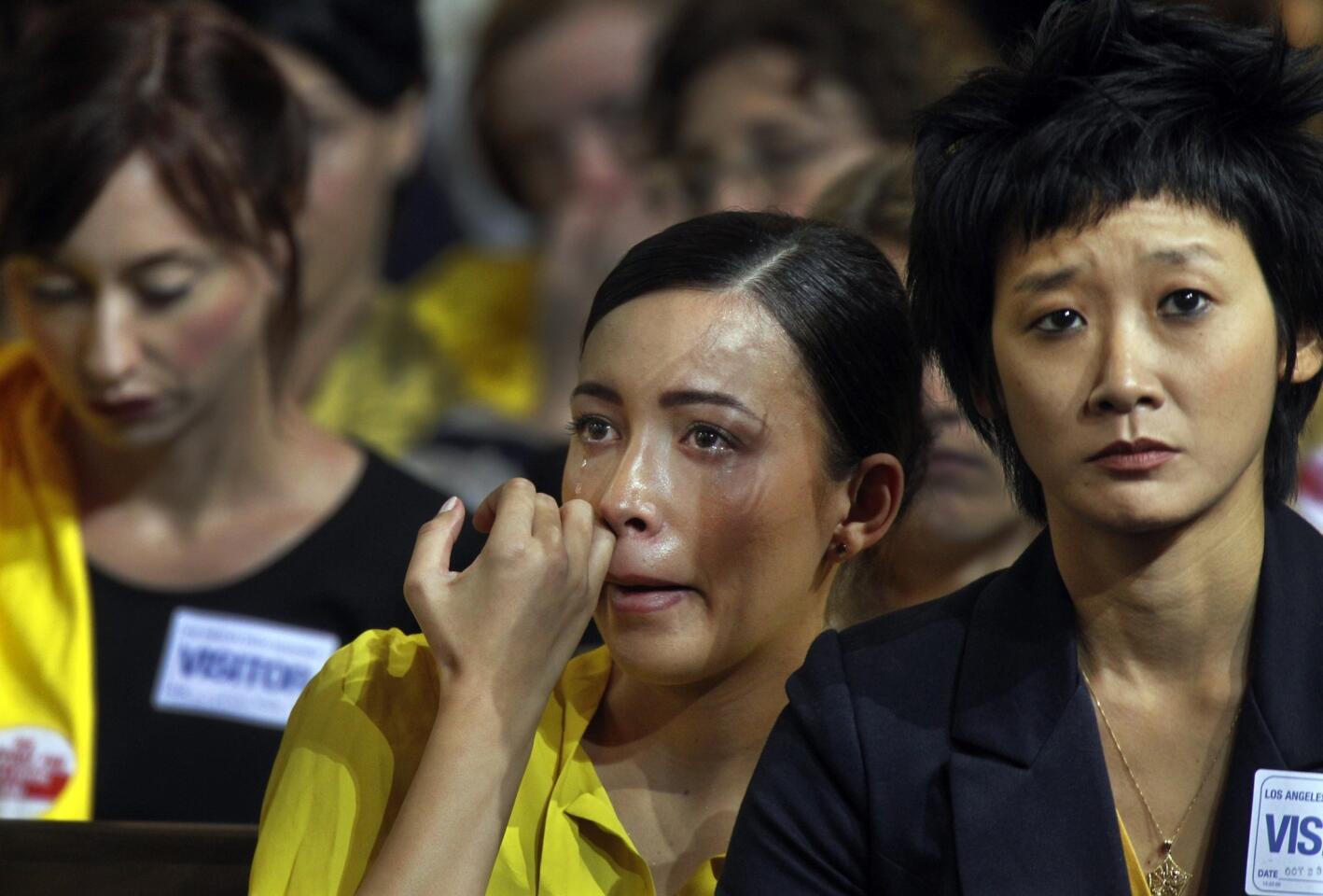 Actress Christian Serratos, center, and Michelle Cho, vice president of the Los Angeles office of the Humane Society, react after watching a video on the use of bullhooks on elephants in traveling circuses. The video was shown by L.A. Councilman Paul Koretz. The council decided to seek a ban on the use of bullhooks in Los Angeles.