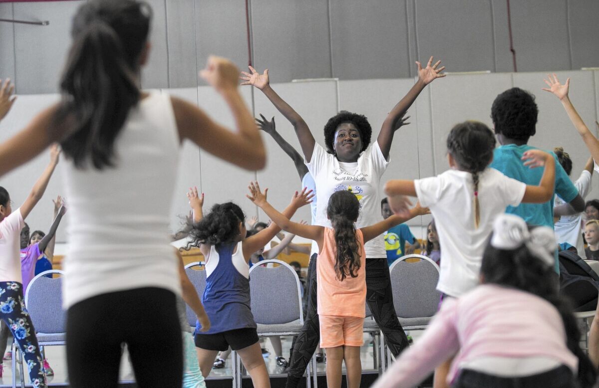 Irishia Hubbard leads students in a tap dance class during the "Shining Stars" Summer Dance Program at UC Irvine on Wednesday, August 12.