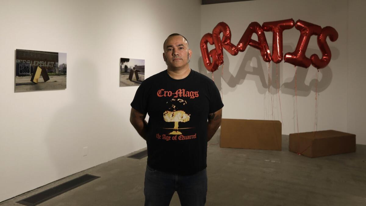 L.A. artist Juan Capistran in front of one of his installations at the Barnsdall Art Park exhibition.
